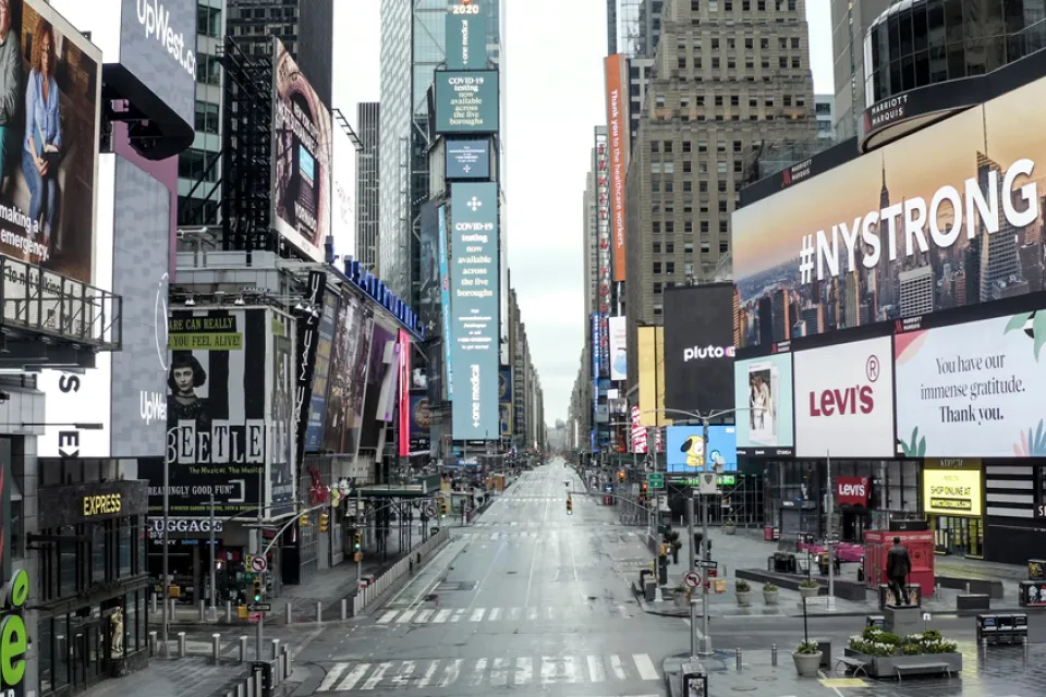 Empty New York City street during the COVID-19 pandemic with #NYSTRONG billboard in foreground.